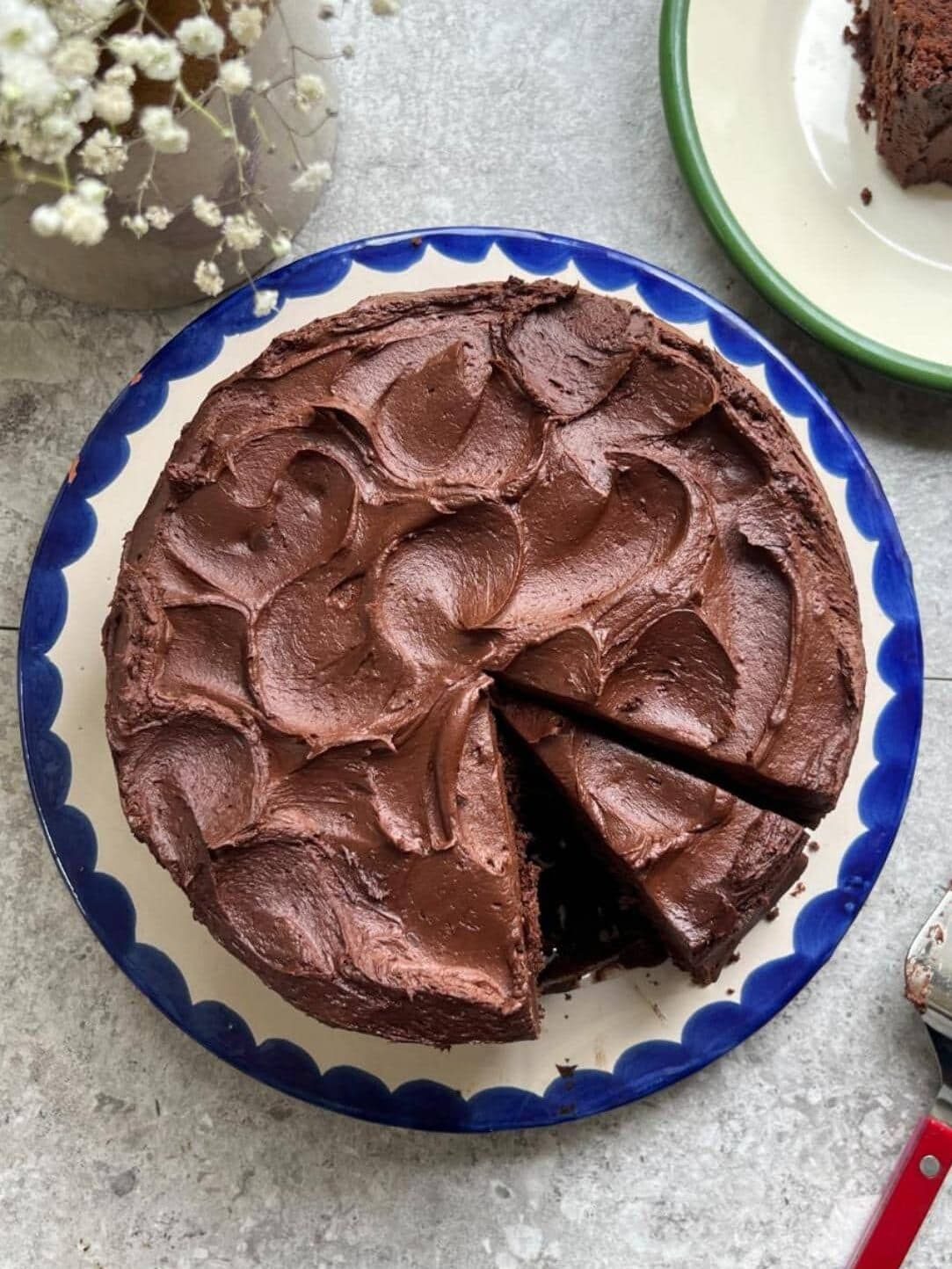matilda's chocolate cake on a white plate with blue trim.