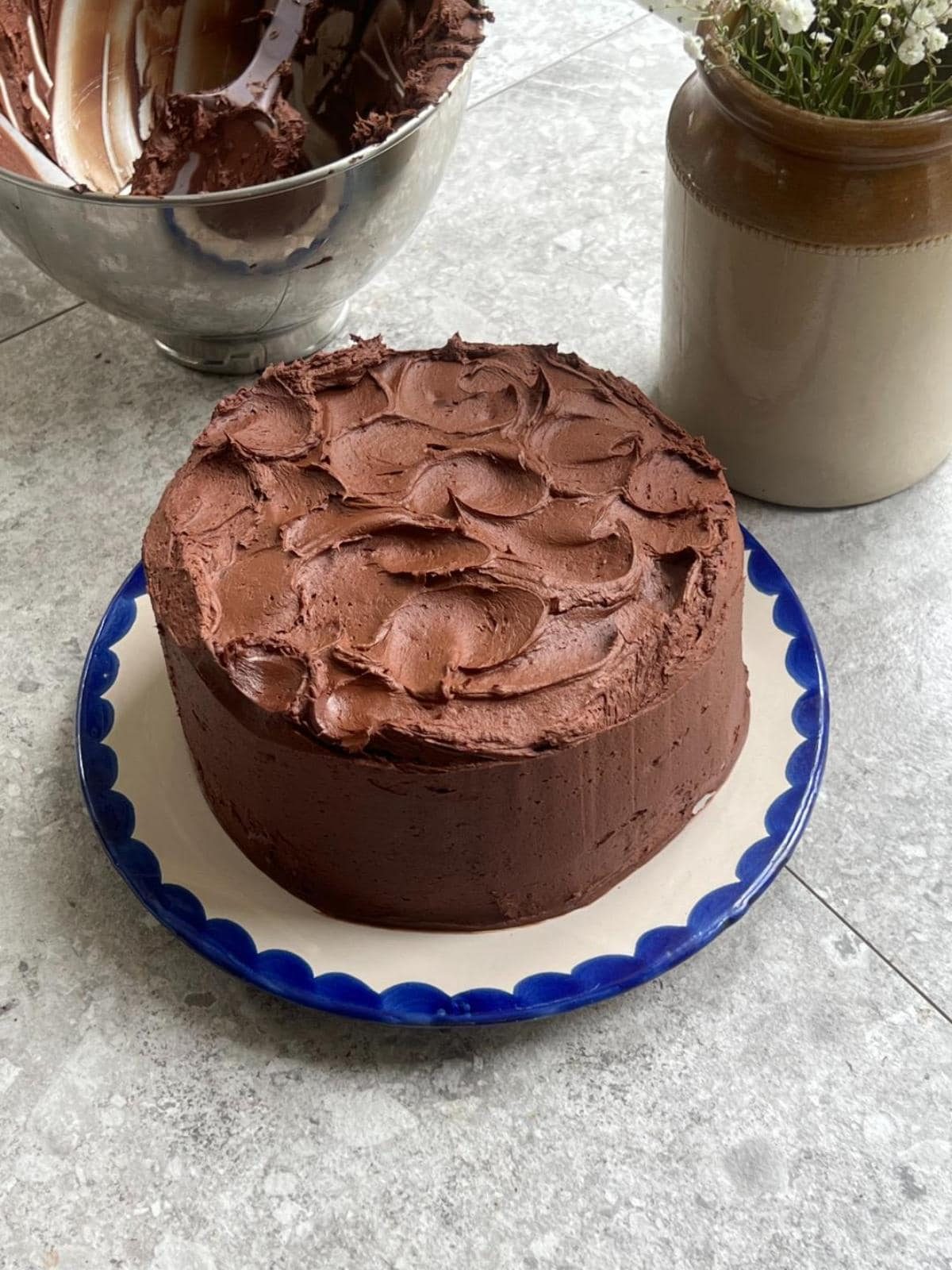 matilda's chocolate cake on a white plate with blue trim.