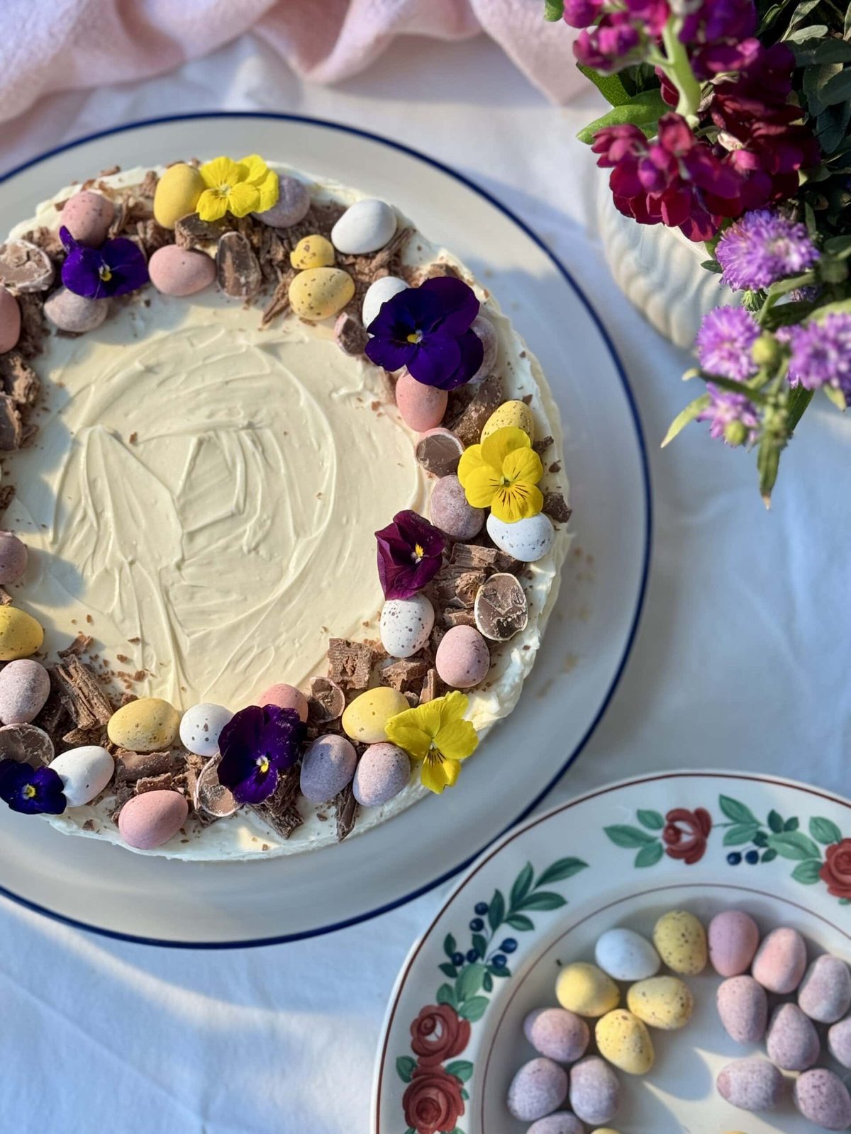 mini egg cheesecake decorated with mini eggs and edible flowers.