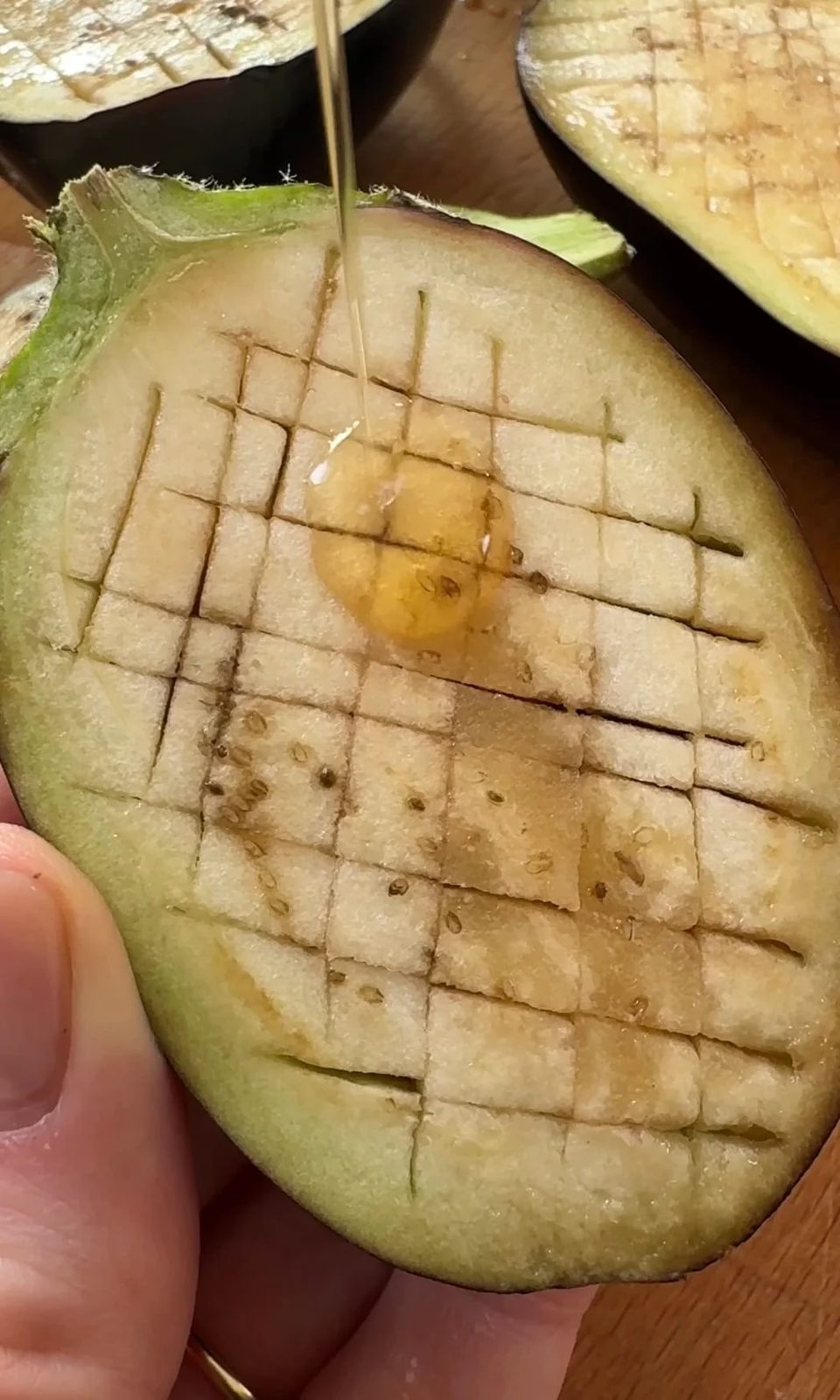 adding oil to aubergine.