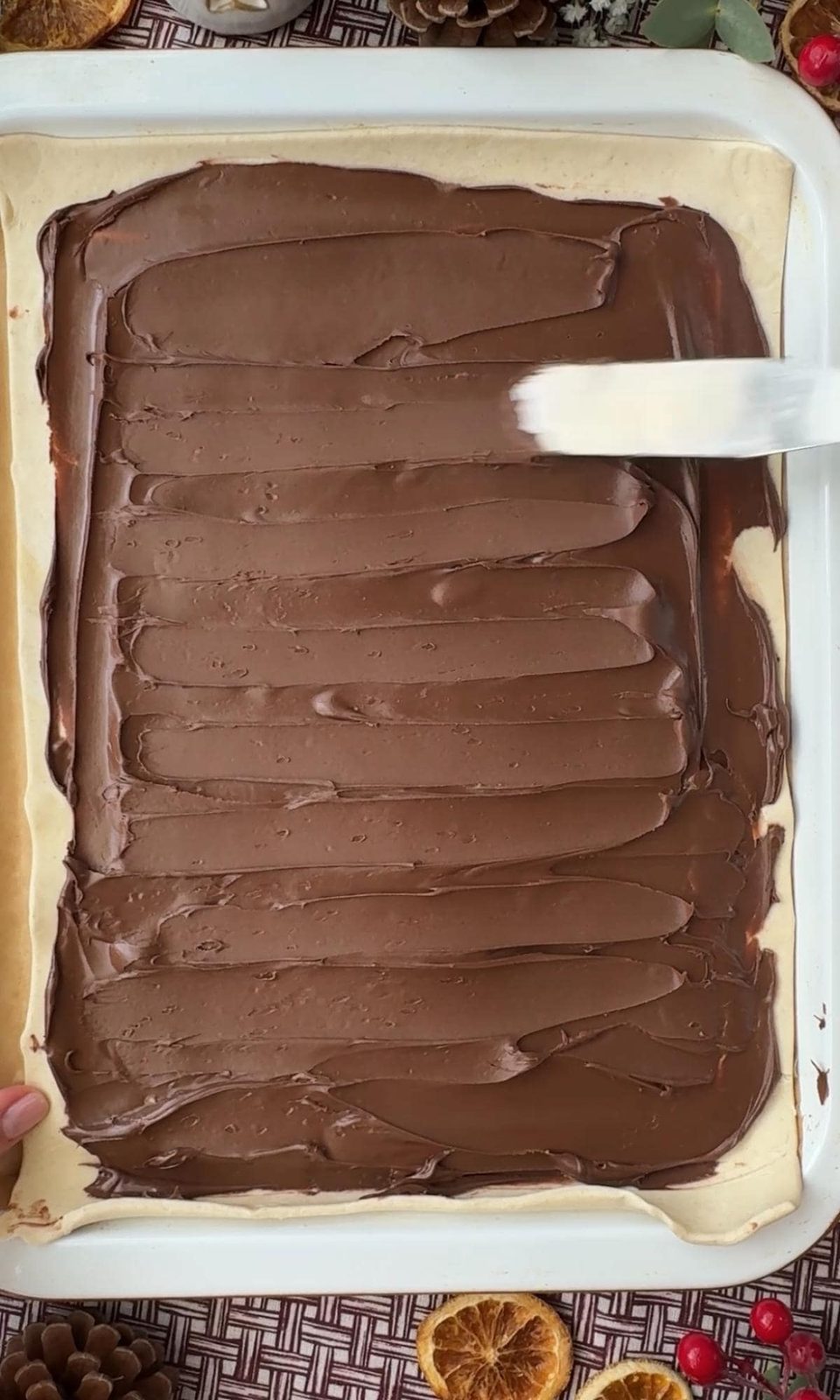 spreading nutella on puff pastry.