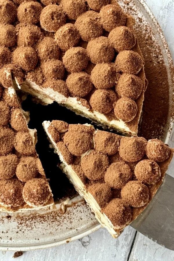 overhead shot of slice removed from tiramisu cheesecake