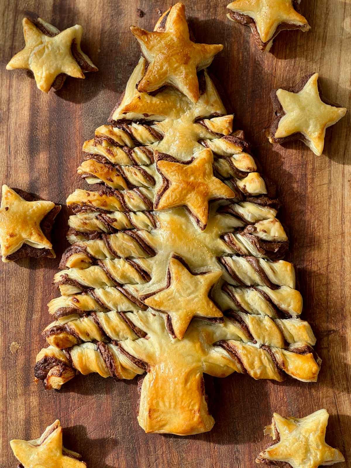 nutella puff pastry christmas tree on a wooden board.