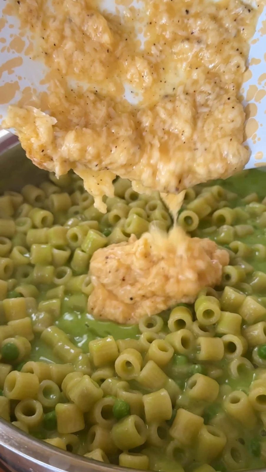 add the whisked egg and cheese to the pan.
