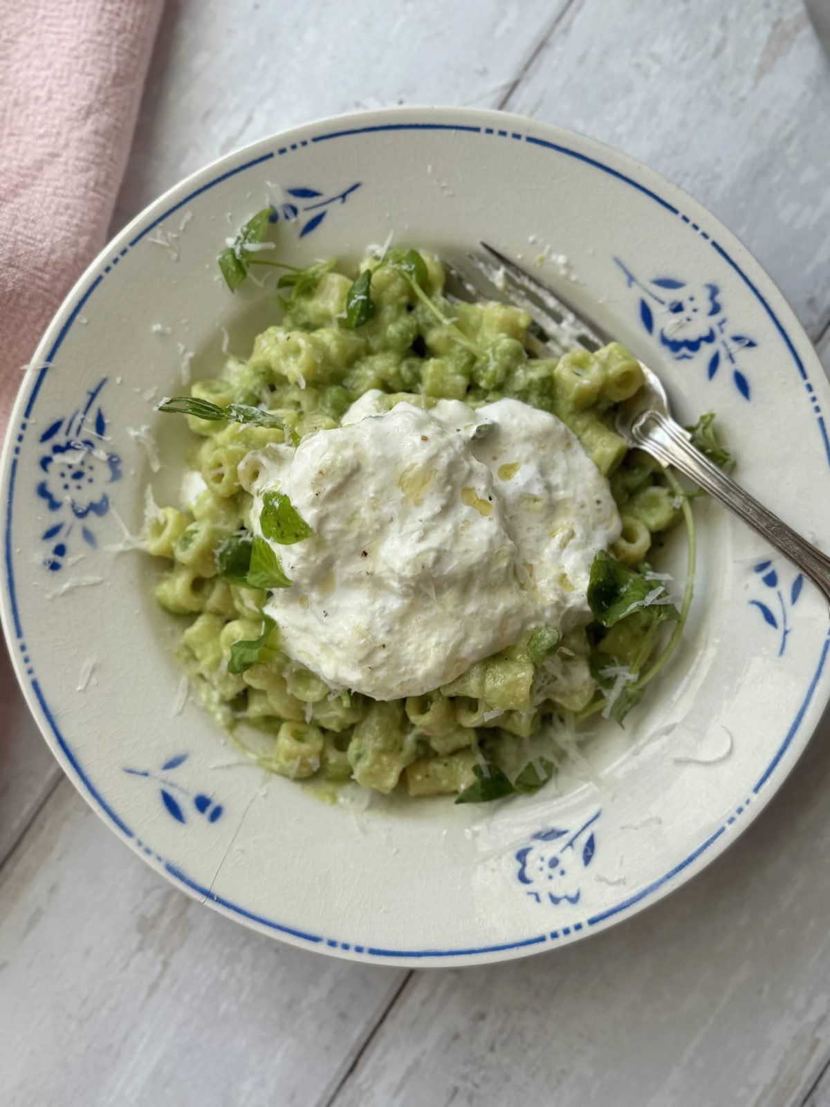 one pan pasta and peas in a bowl with burrata.