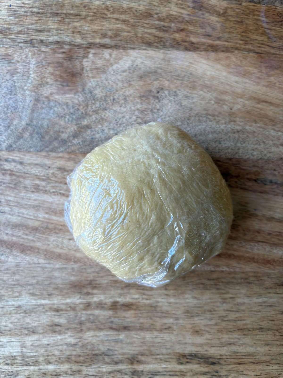 wrapping pasta dough in clingfilm.