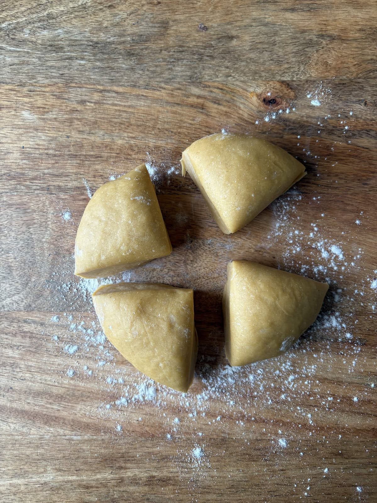 separating the dough into quarters.