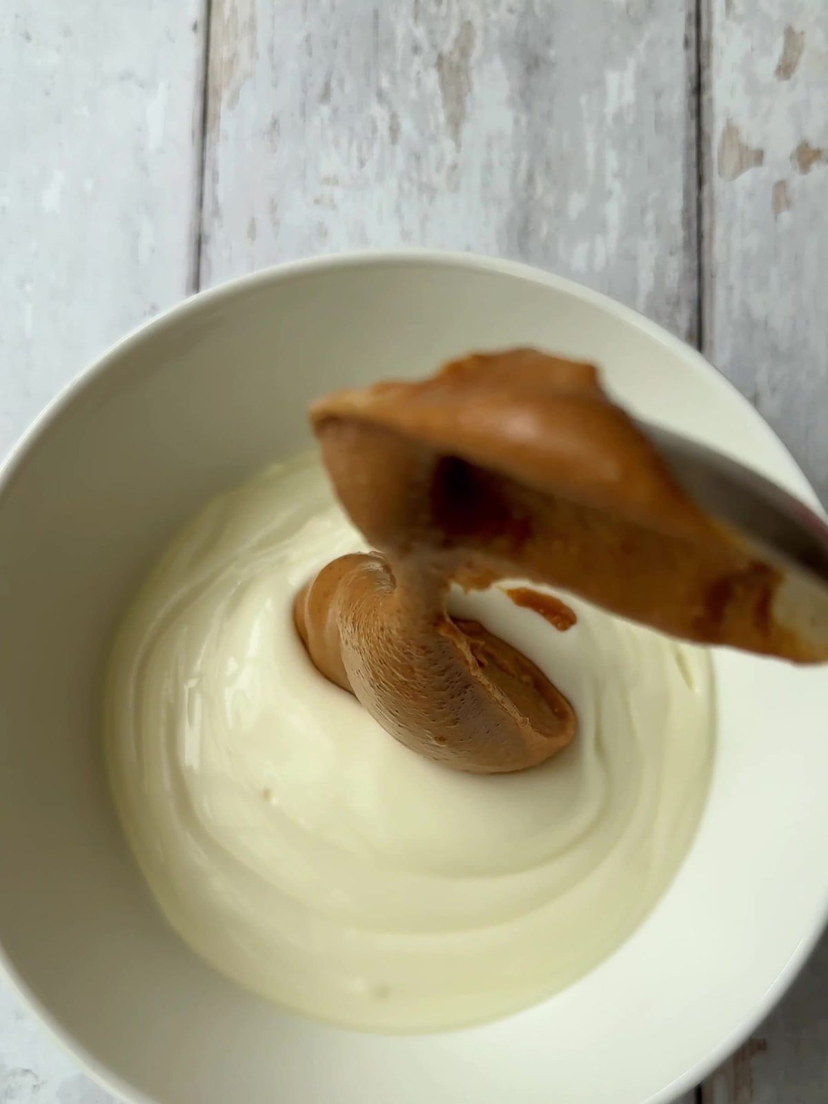 Adding date caramel to greek yogurt.