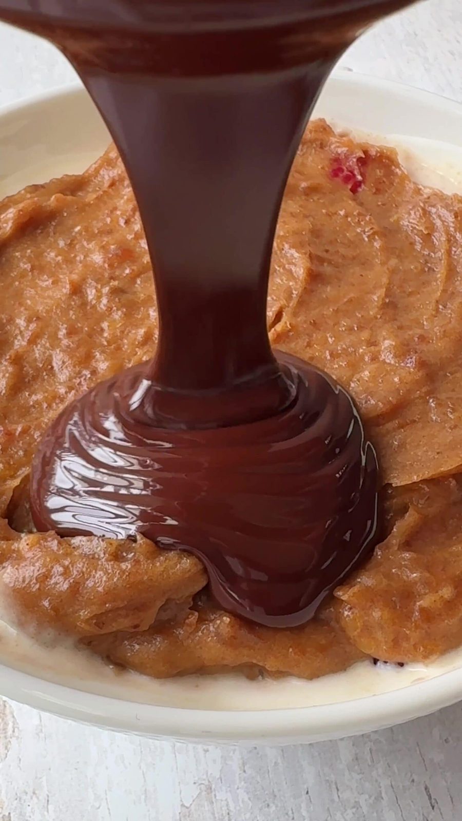 Pouring Chocolate over date caramel.