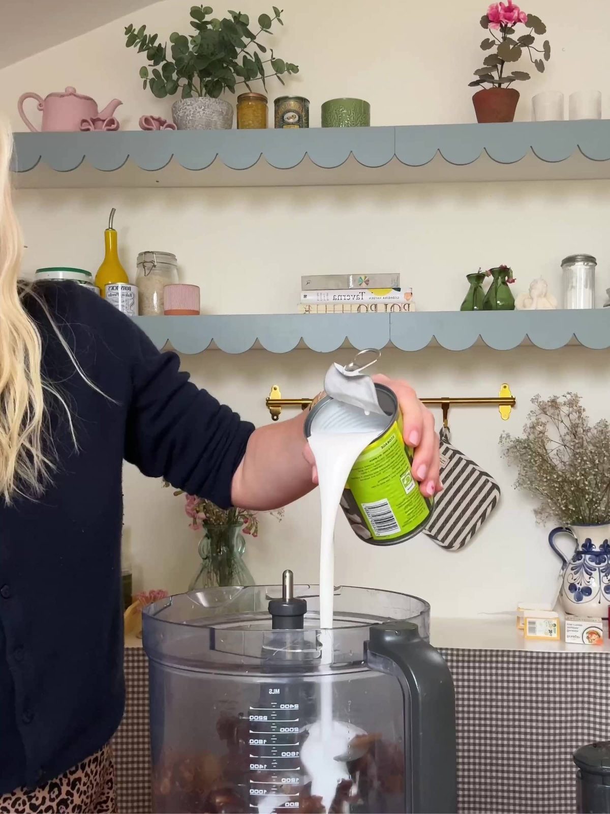 Adding coconut milk in blender.