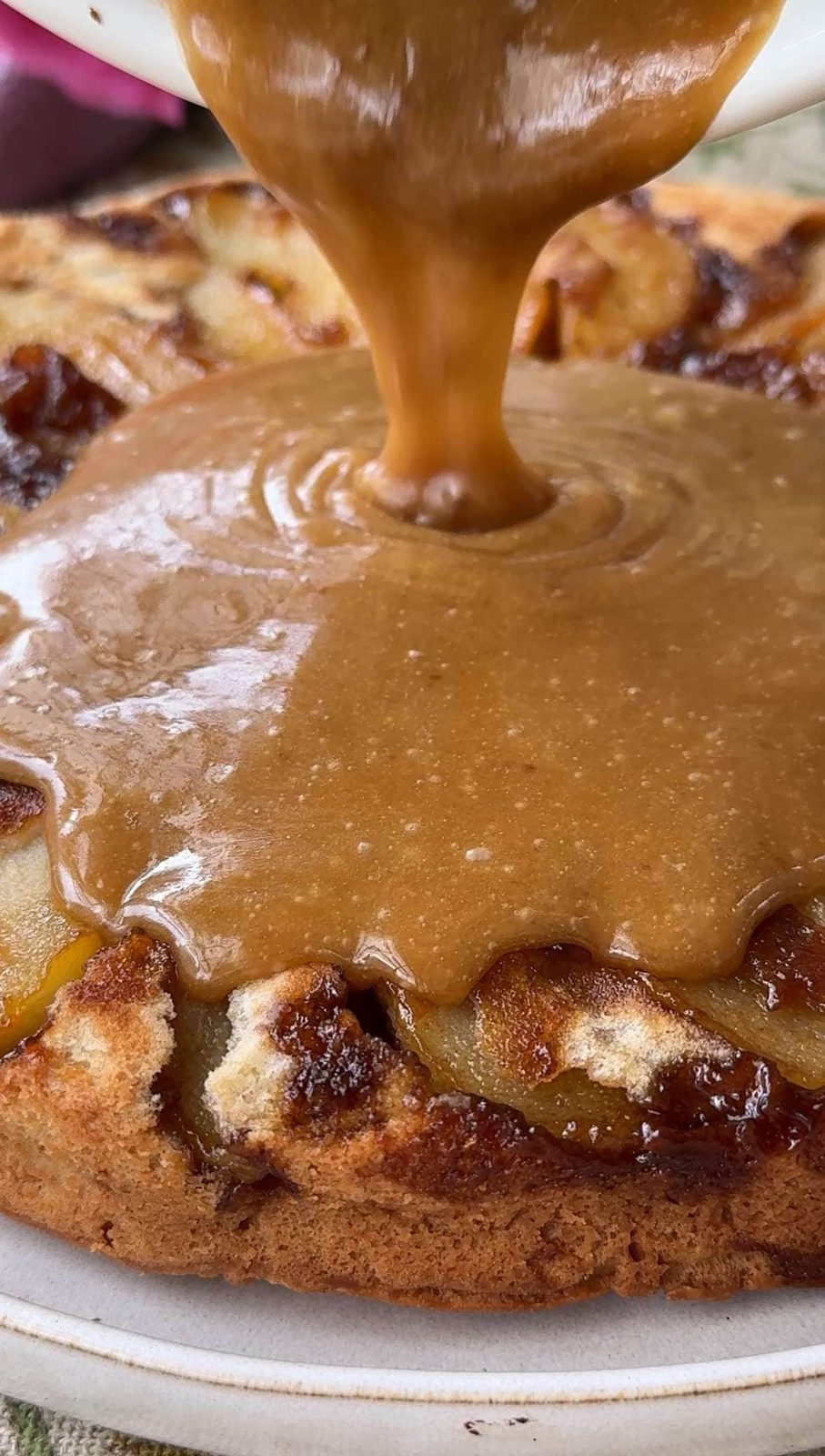 pouring fudge on pear upside down cake,