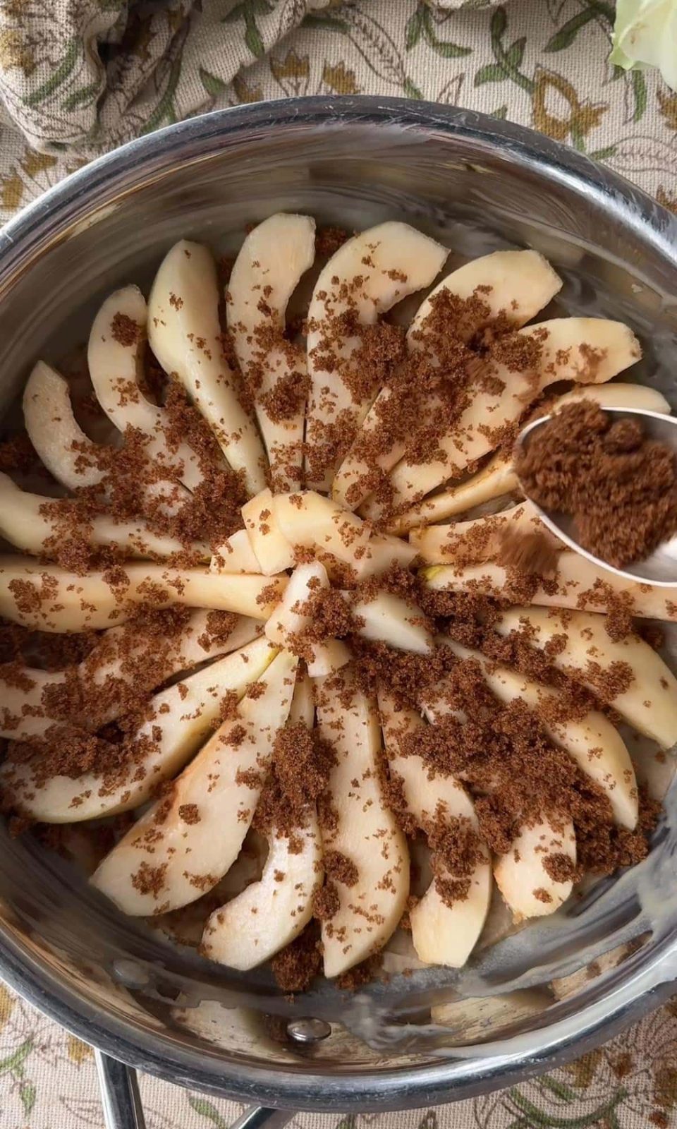 sprinkling brown sugar on pears.
