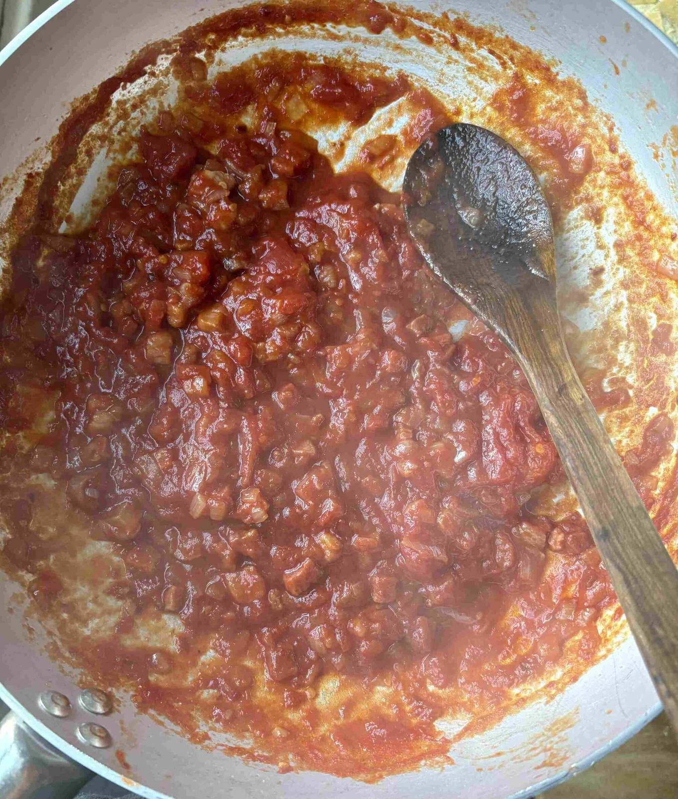 Simmering amatriciana sauce.