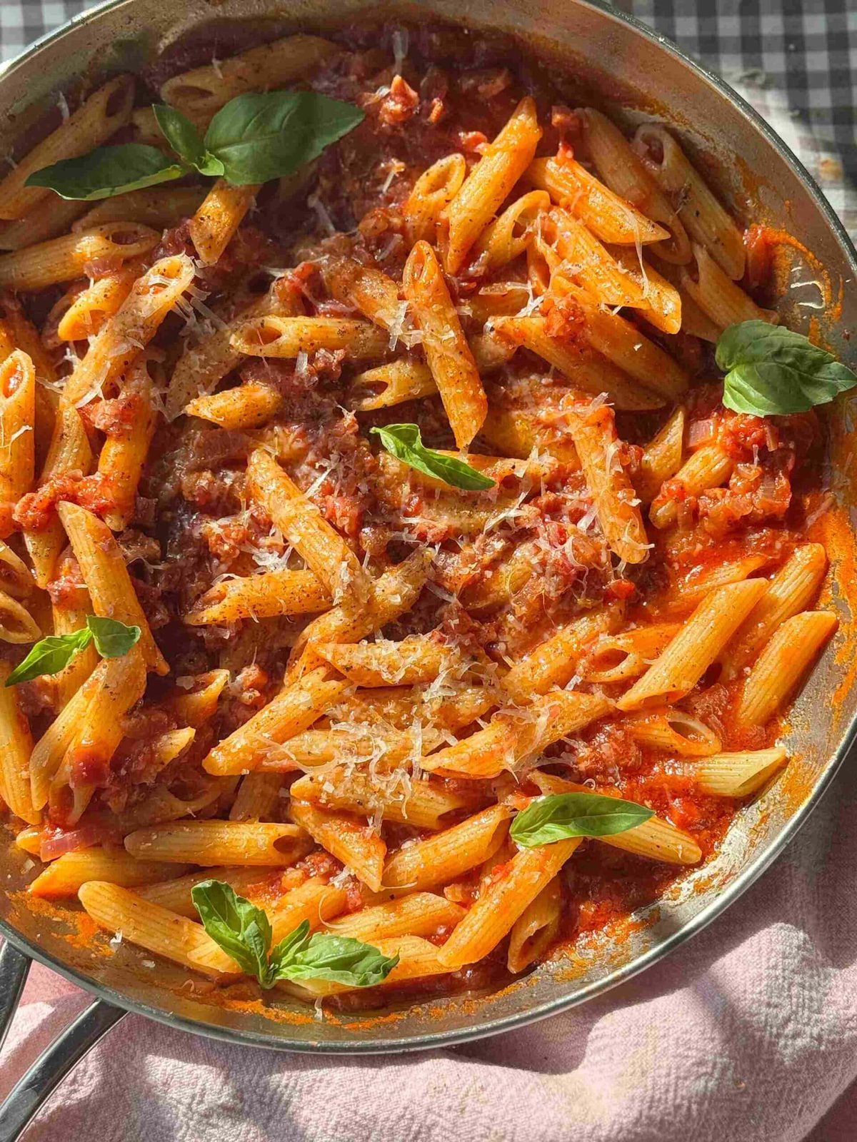 Penne amatriciana in a silver pan.