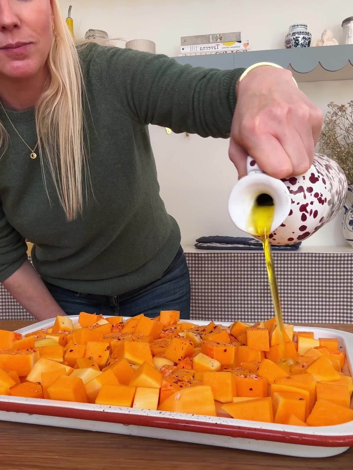 Drizzling butternut with olive oil.