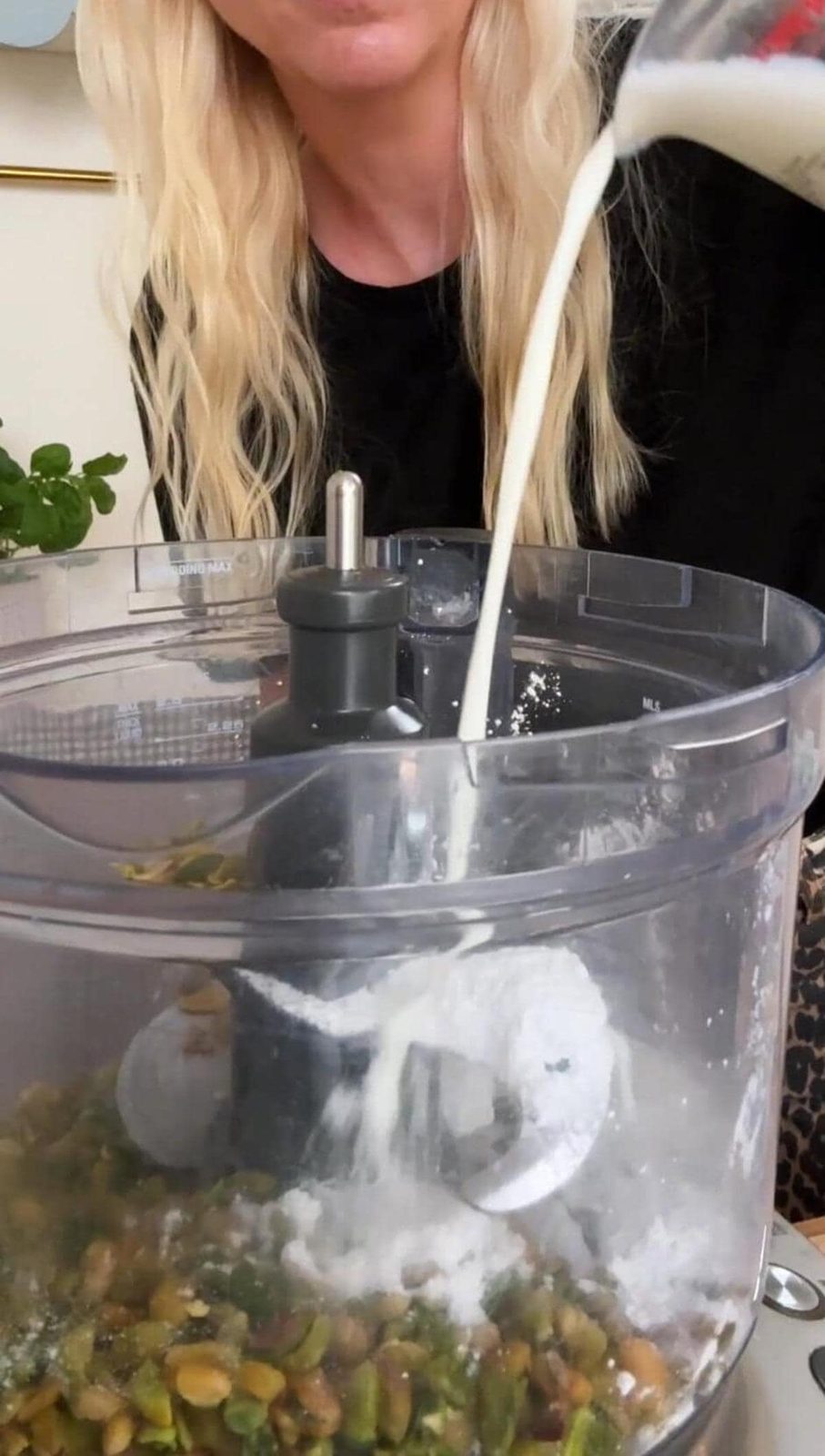 adding milk to the blender.