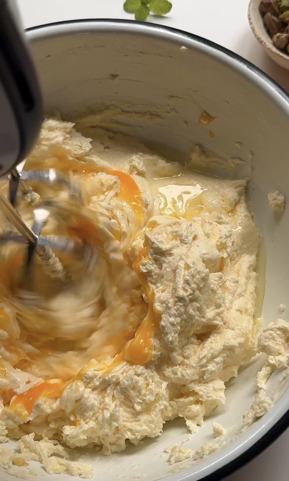 Beating eggs into cake batter.