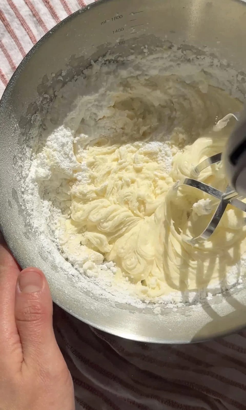 Beating butter and sugar together.