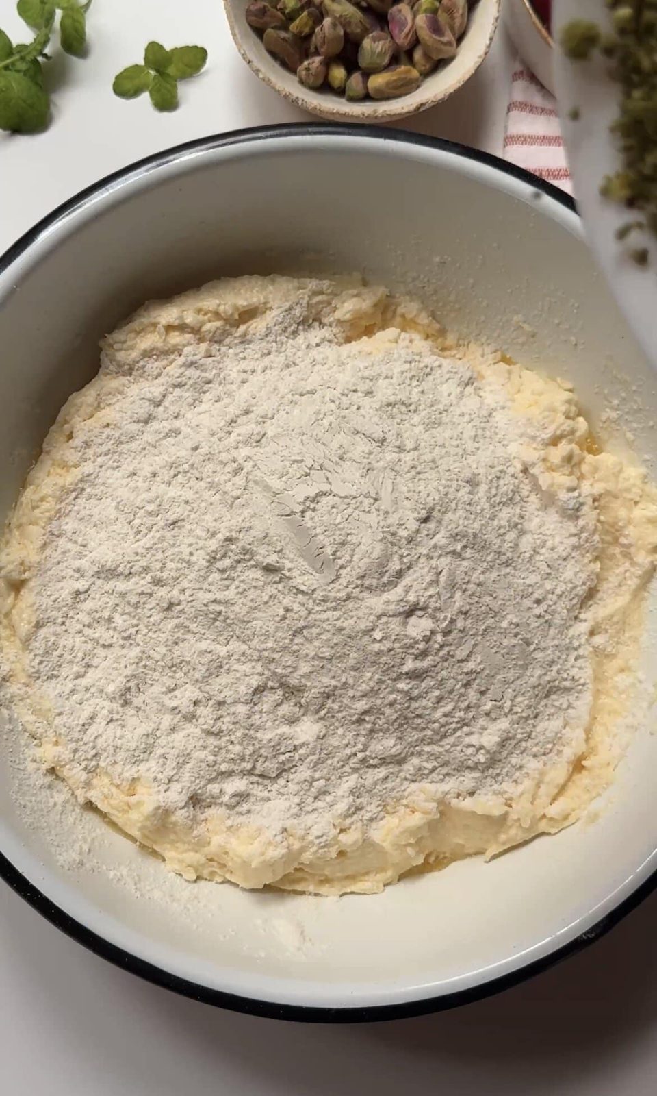 Adding flour to cake batter.