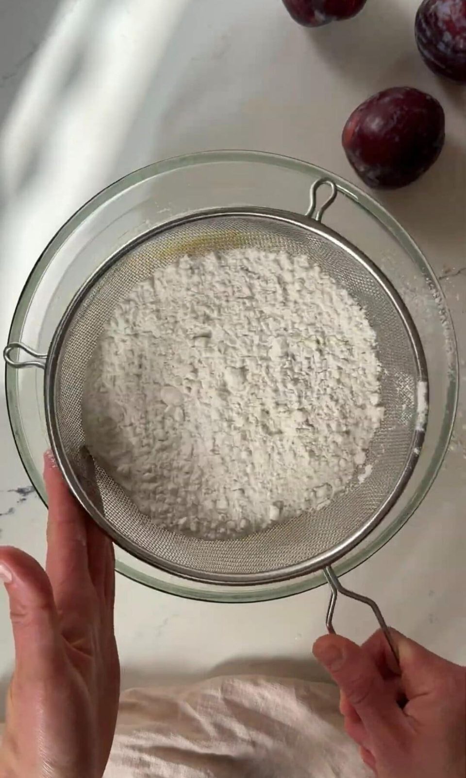 Sifting flour into cake batter.