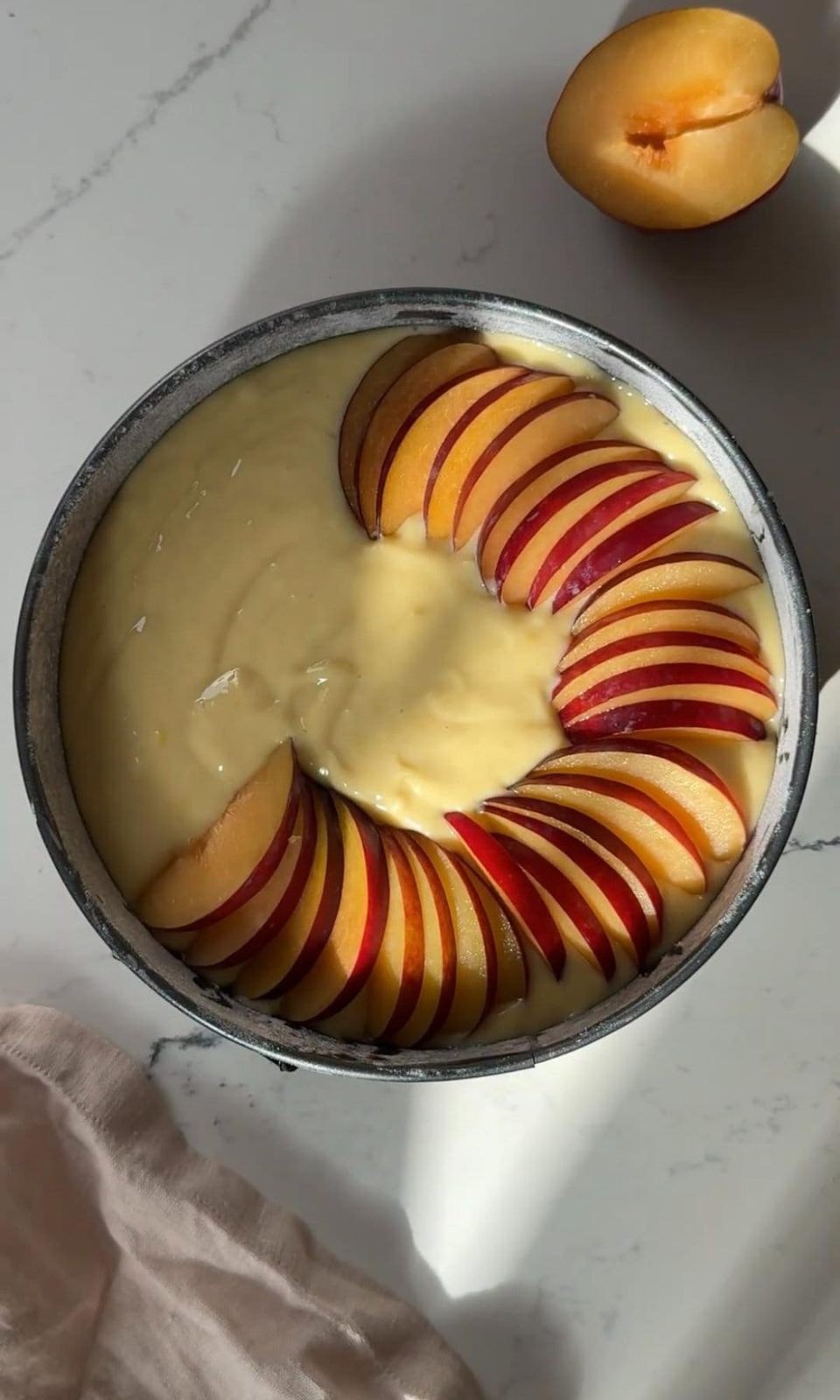 Layering plums on plum yogurt cake.