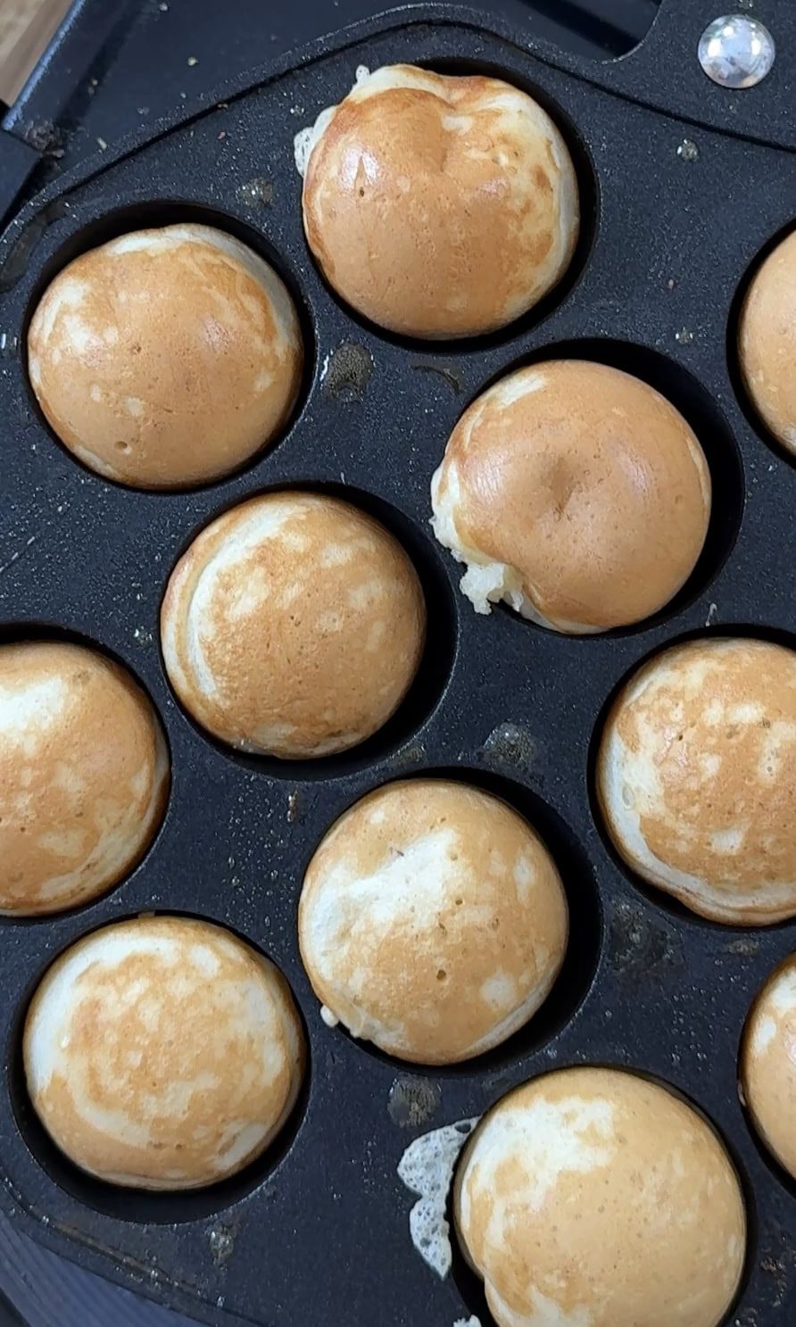 Baked poffertjes in the pan.