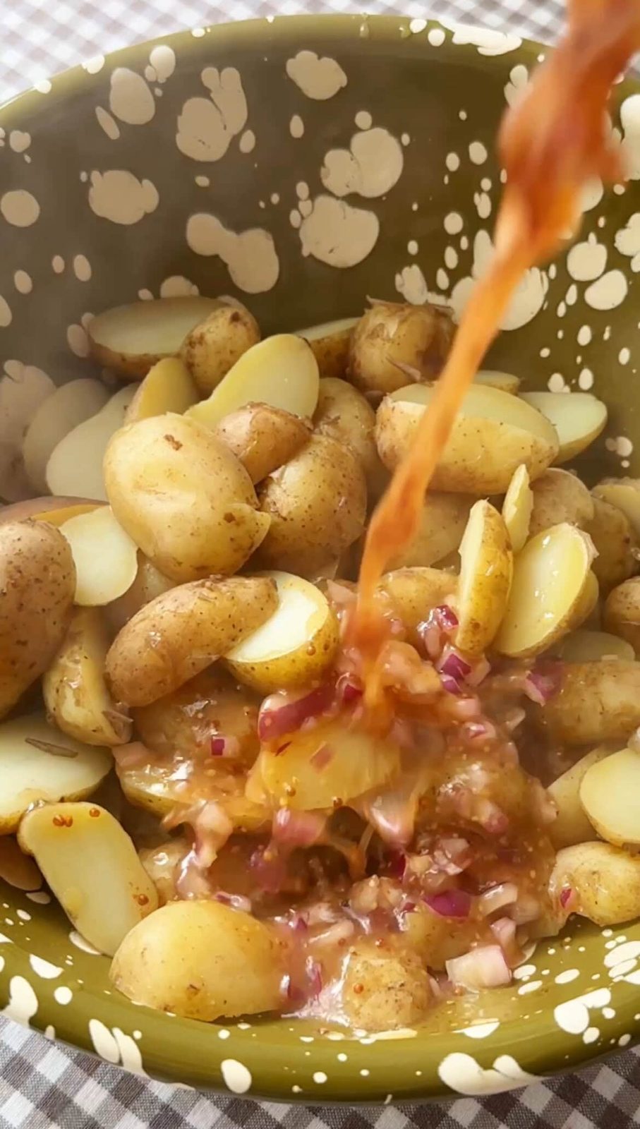adding dressing to potatoes.