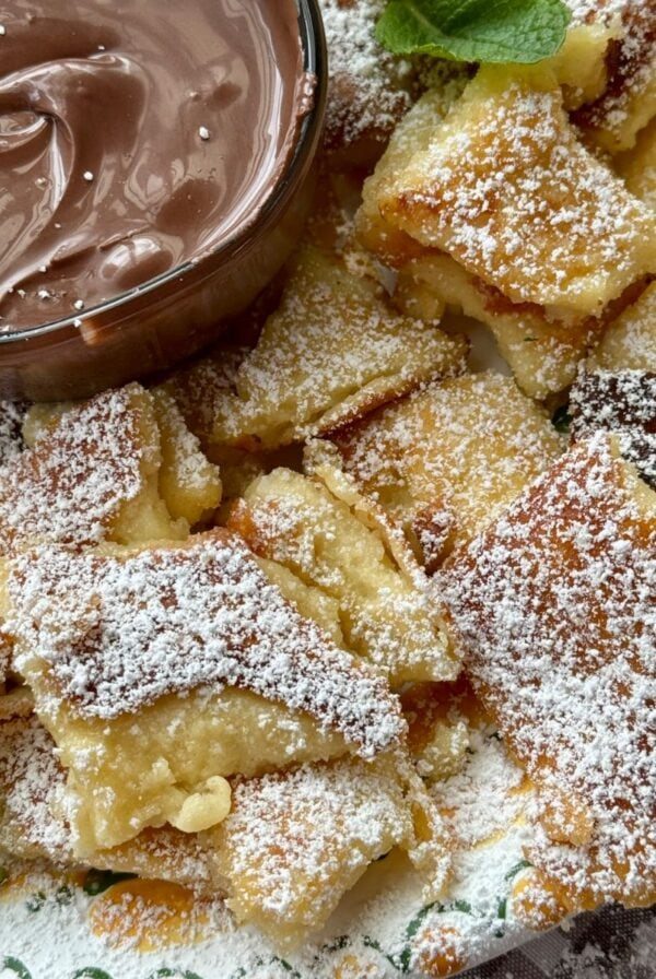 Kaiserschmarrn on a plate with powdered sugar.