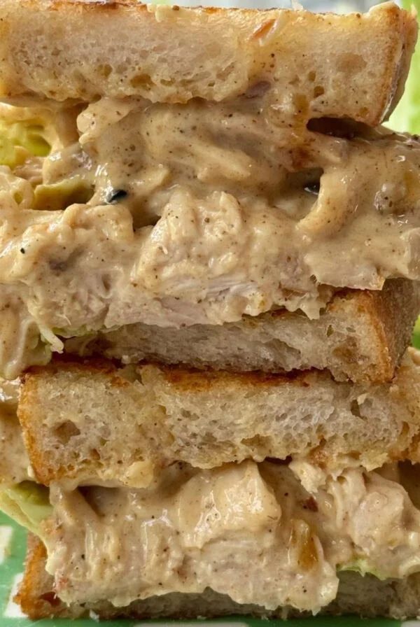 chicken coronation sandwich in half with lettuce.