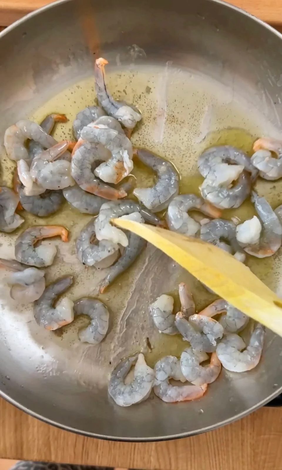 Prawns frying in pan.