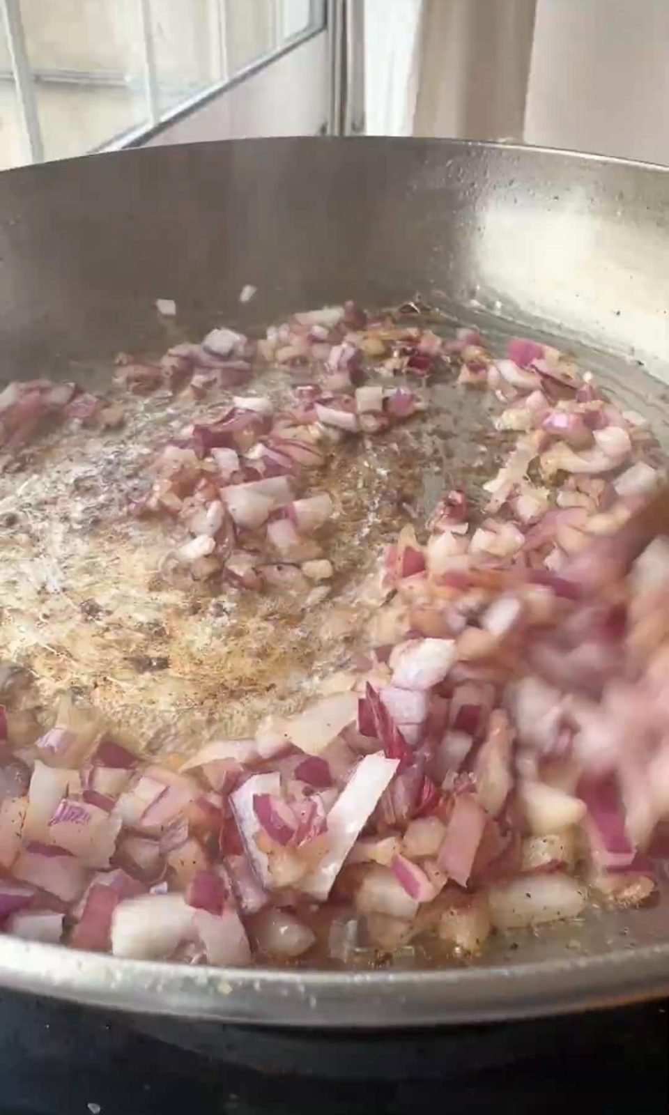 Sautéing onions and garlic in pan.