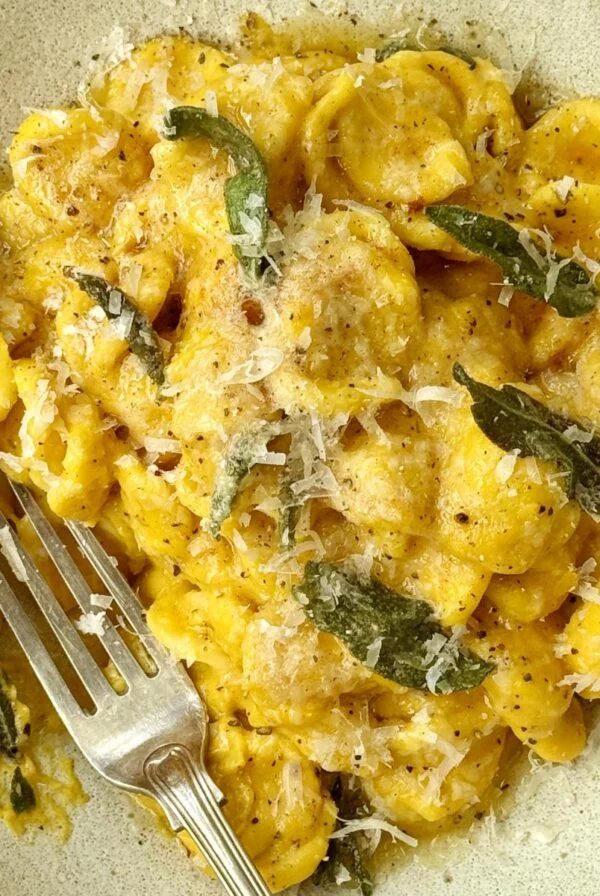 bowl of butternut pasta with crispy sage on top.