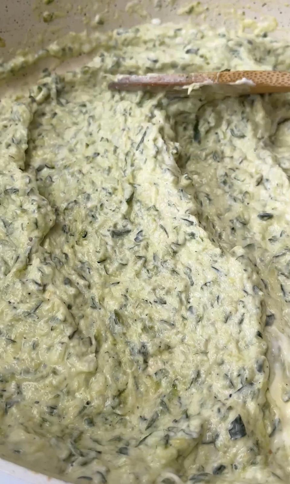 mixing courgette sauce.