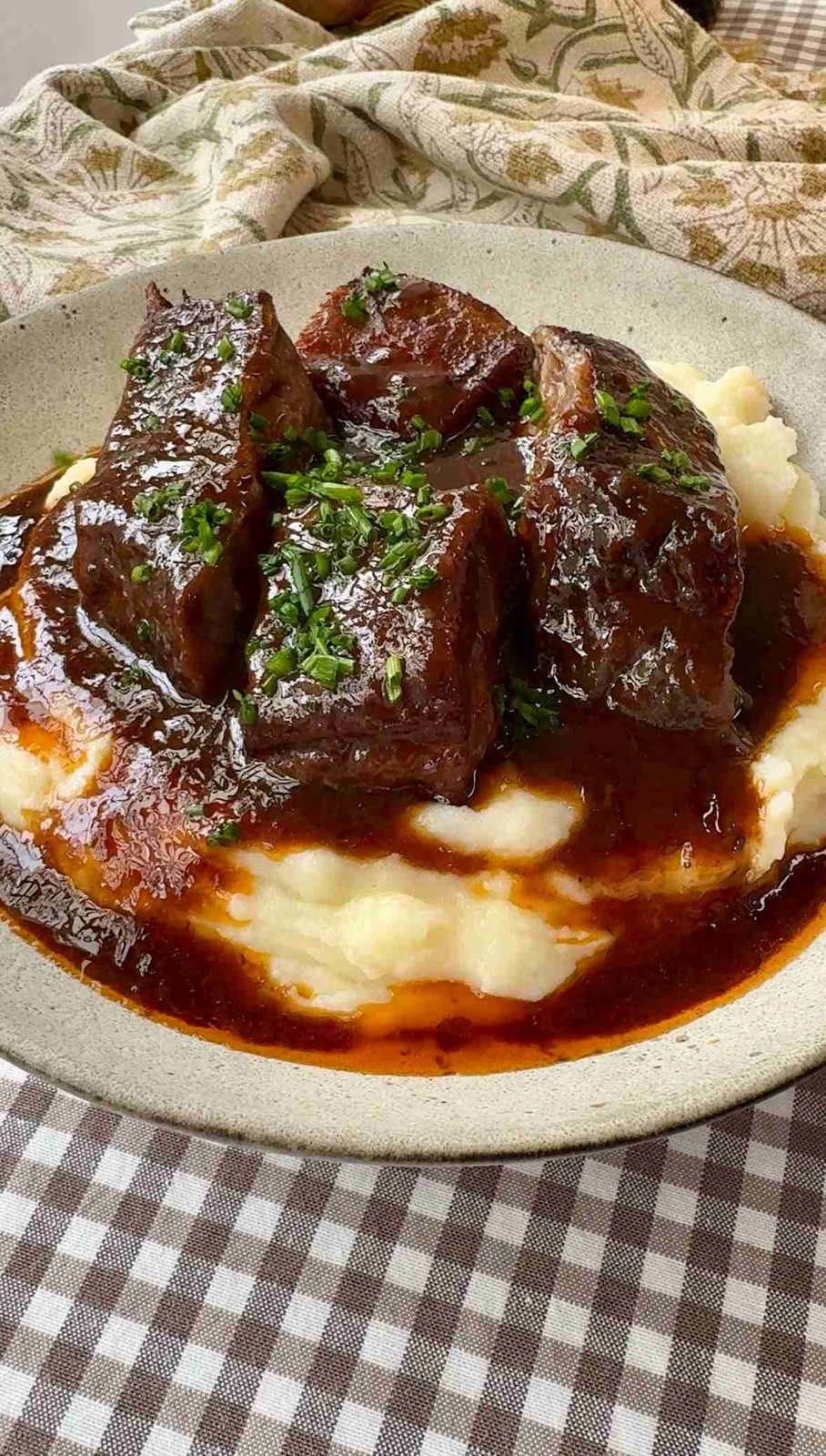 Close-up of braised beef short ribs with red wine sauce.