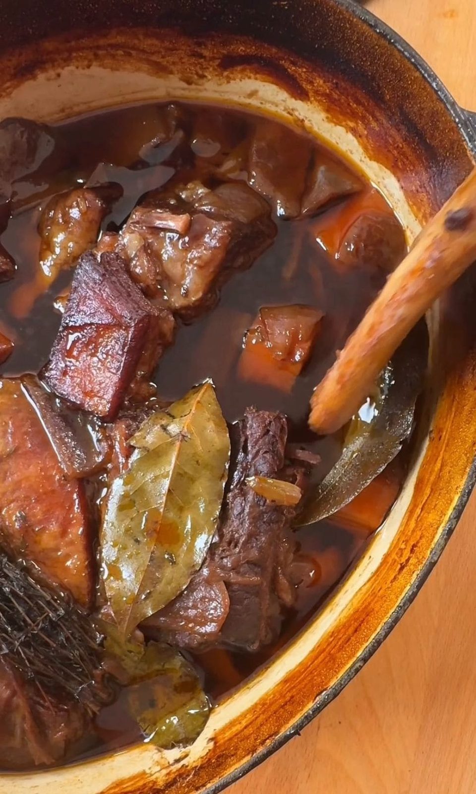 Removing bones from tender braised short ribs.