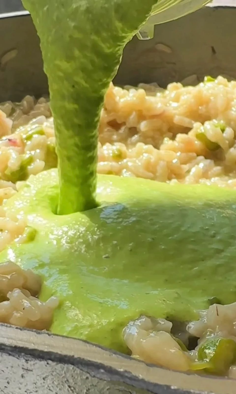 adding blended peas to the asparagus risotto.
