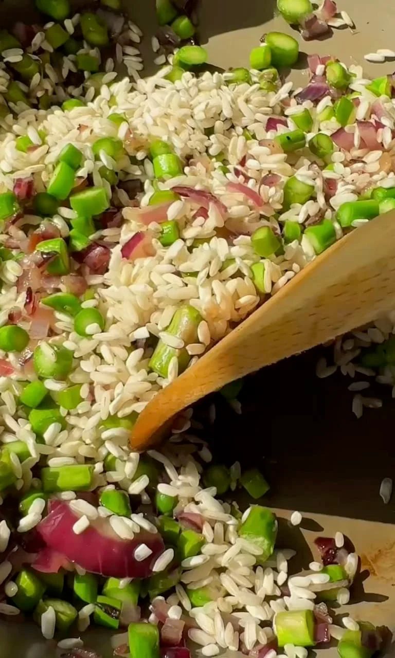 adding asparagus to the risotto.