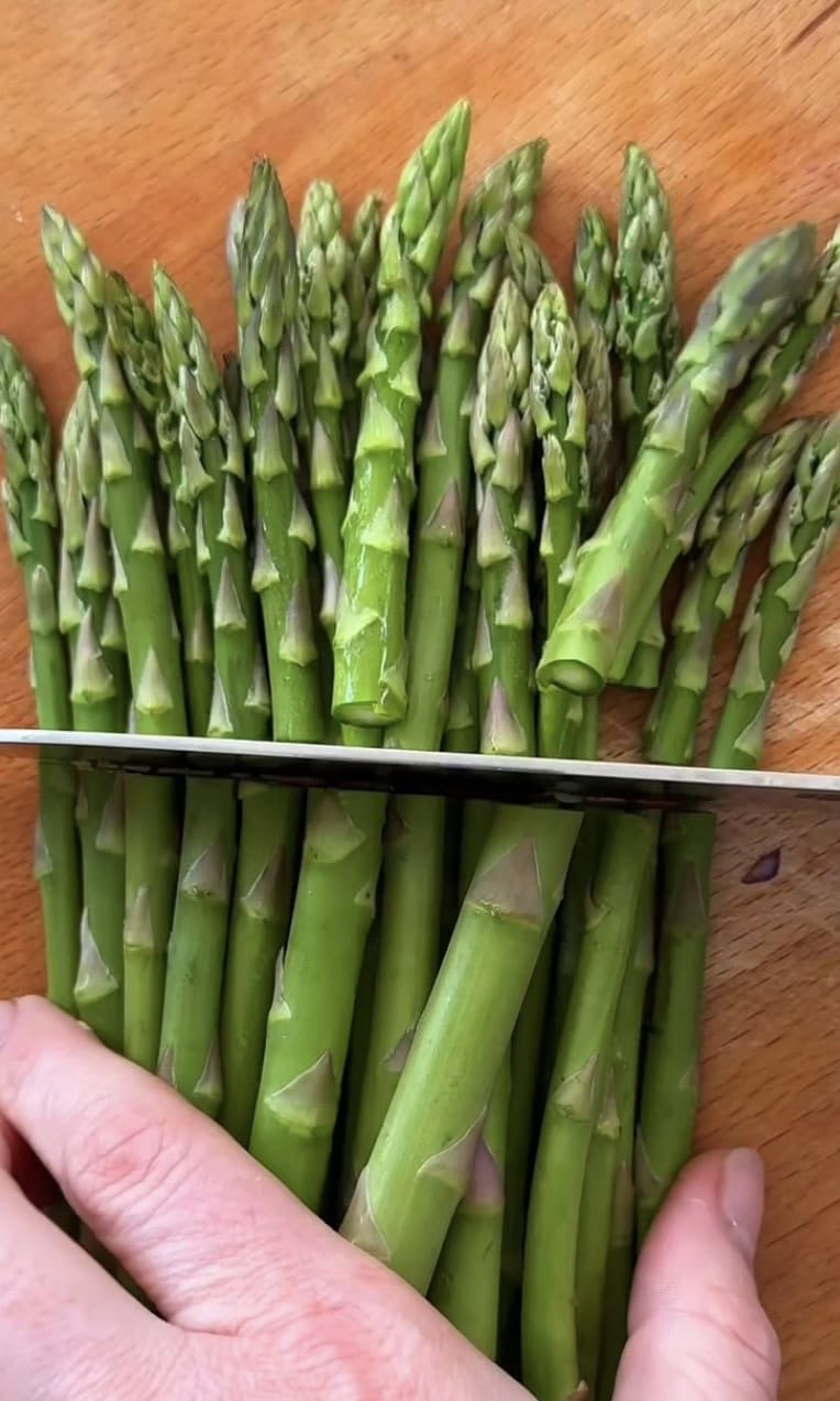 slicing spears off asparagus.