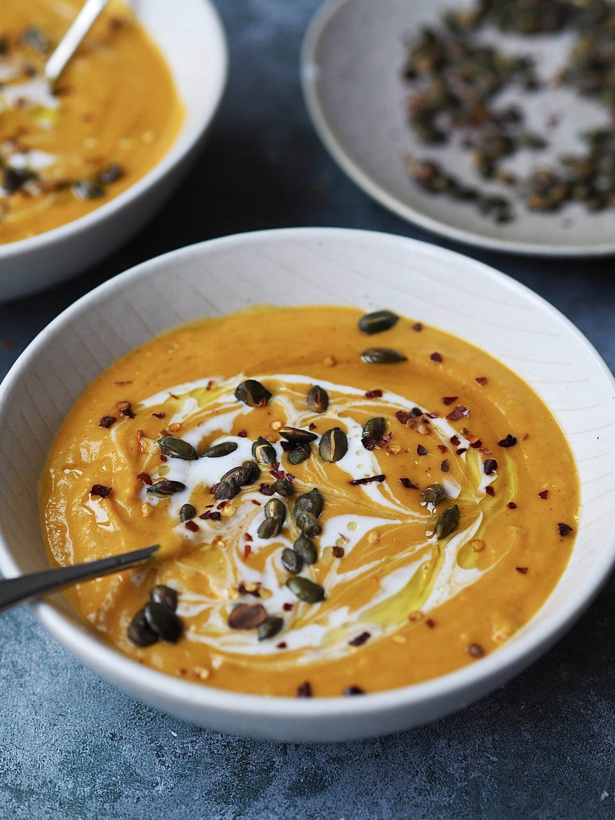 Butternut squash soup close up in a white bowl.