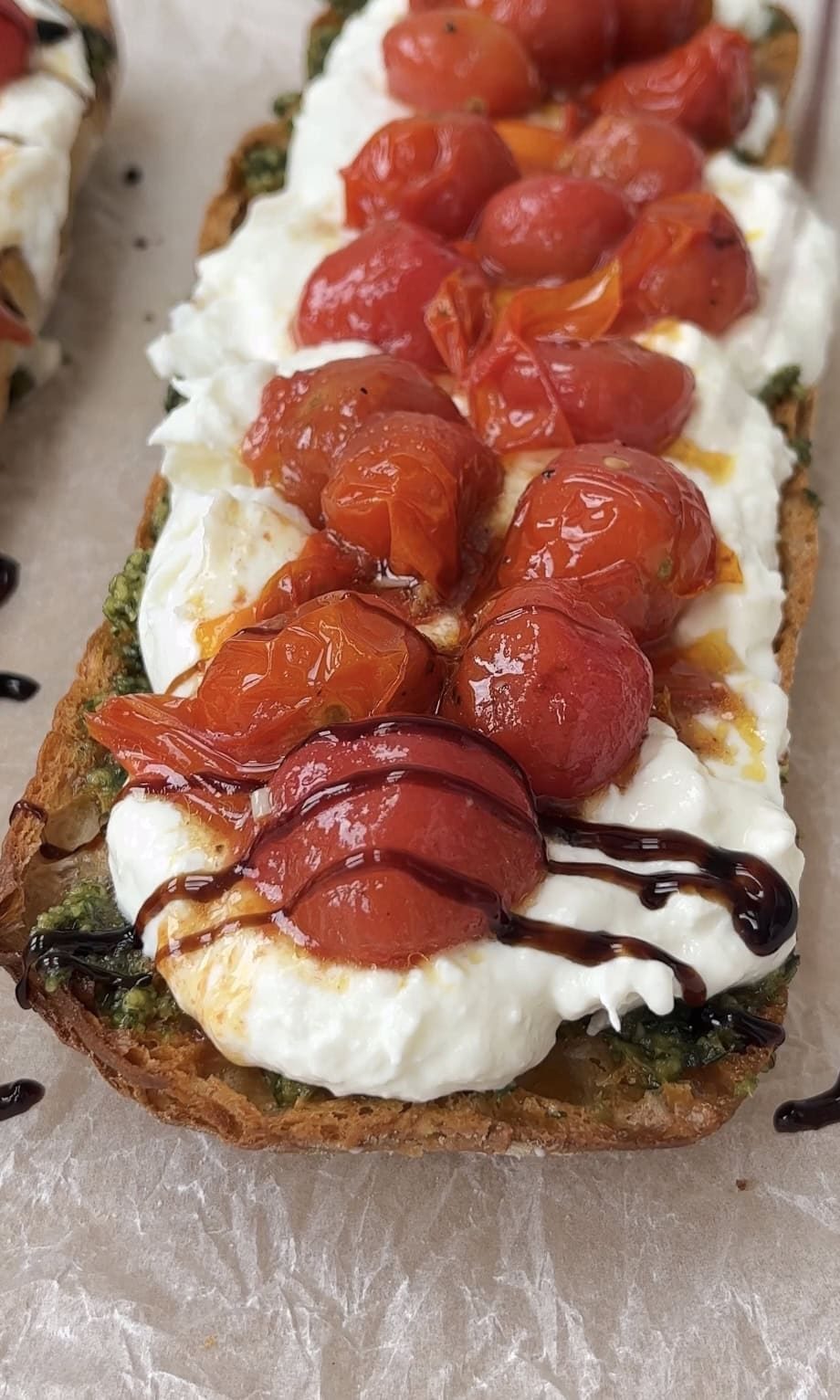 drizzling caprese bruschetta with balsamic glaze.