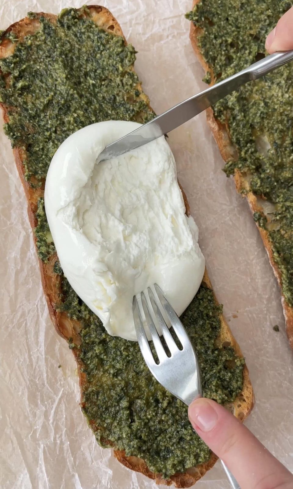 smoothing burrata onto ciabatta.