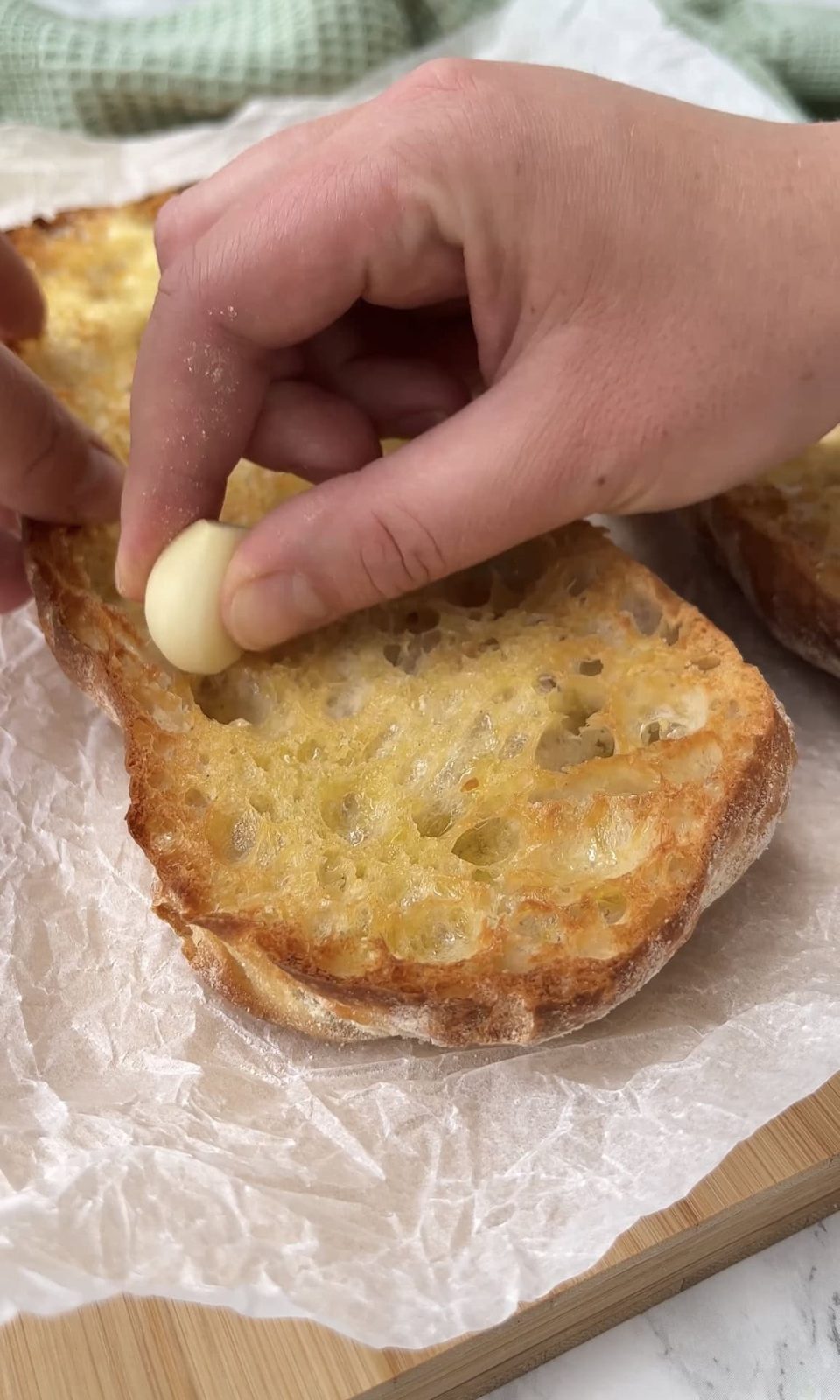 rubbing ciabatta with garlic.