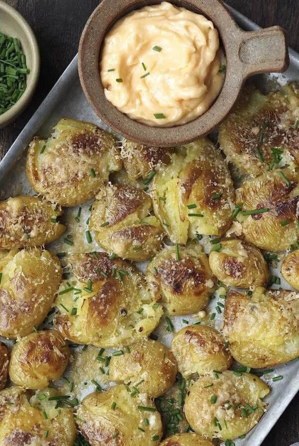 cheesy smashed potatoes on a tray.