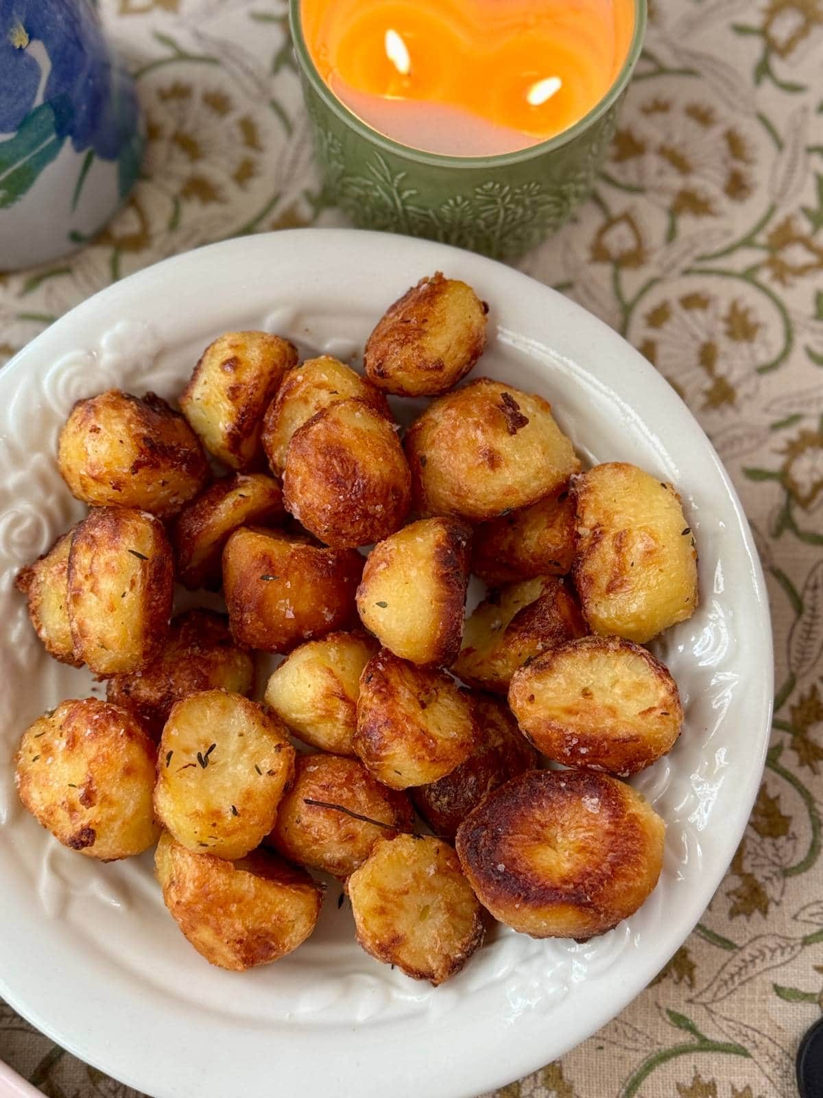 roasted white potatoes with rosemary in a white bowl.