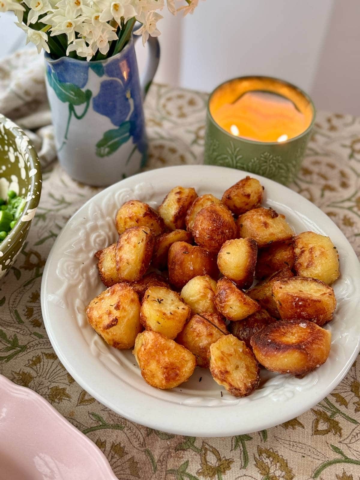 roasted white potatoes with rosemary in a white bowl.
