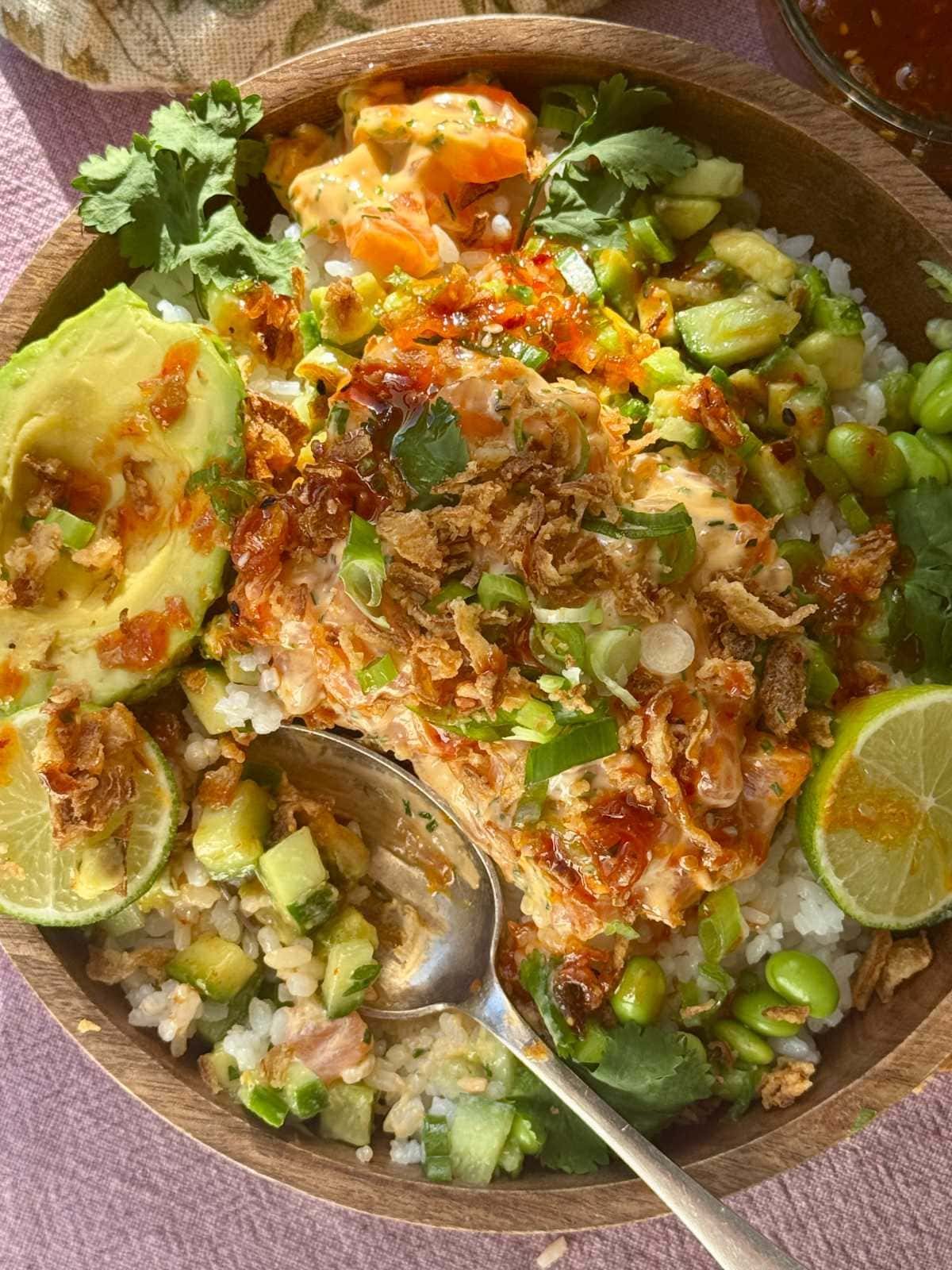 Salmon bowls with sushi rice, lime, and scallions.