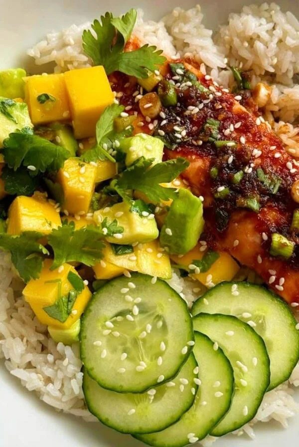 teriyaki salmon bowl with mango avocado salsa and rice.