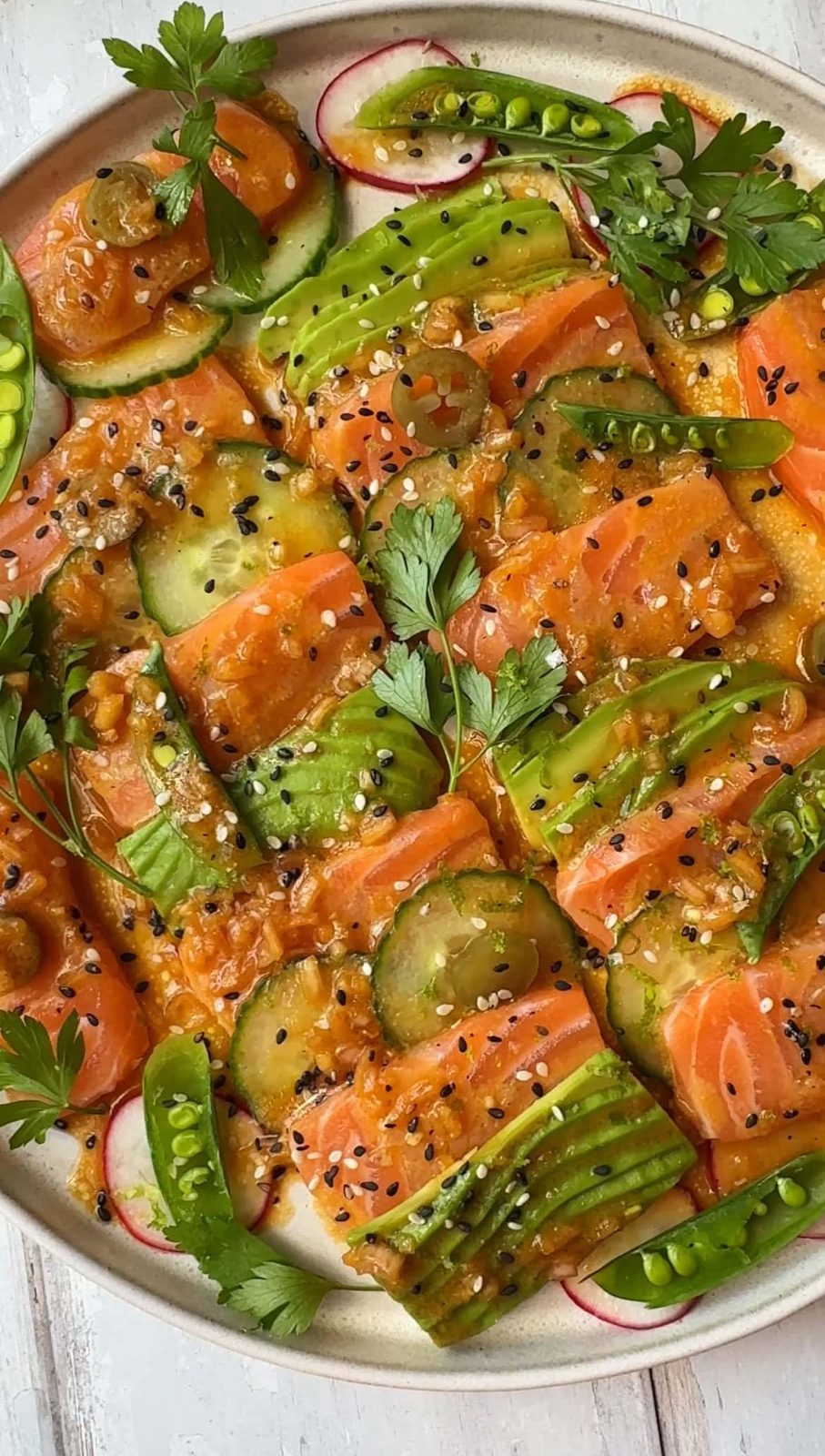 salmon crudo with garnishes and dressed.