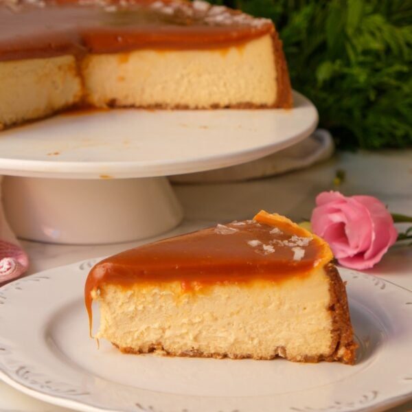salted caramel cheesecake slice on a white plate.