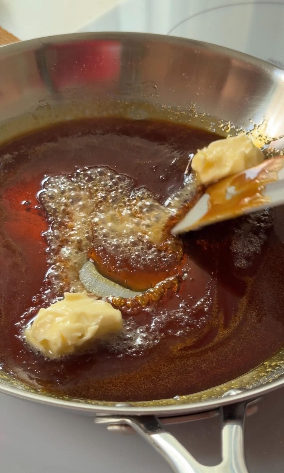 adding butter to melted sugar.